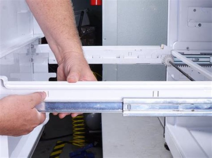 How do you remove a refrigerator drawer